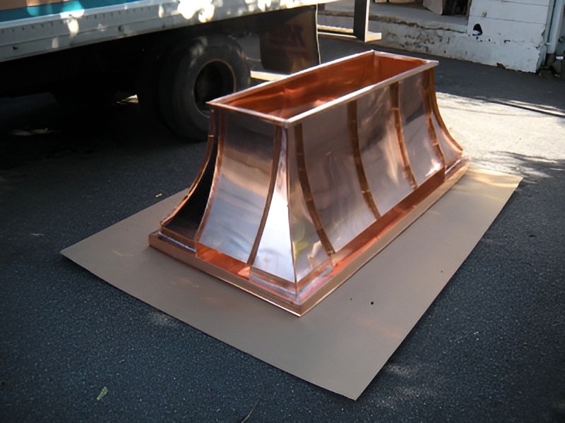 Copper chimney cap polished and ready for installation.