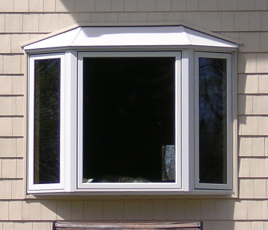 White coated islander roof on a bay window