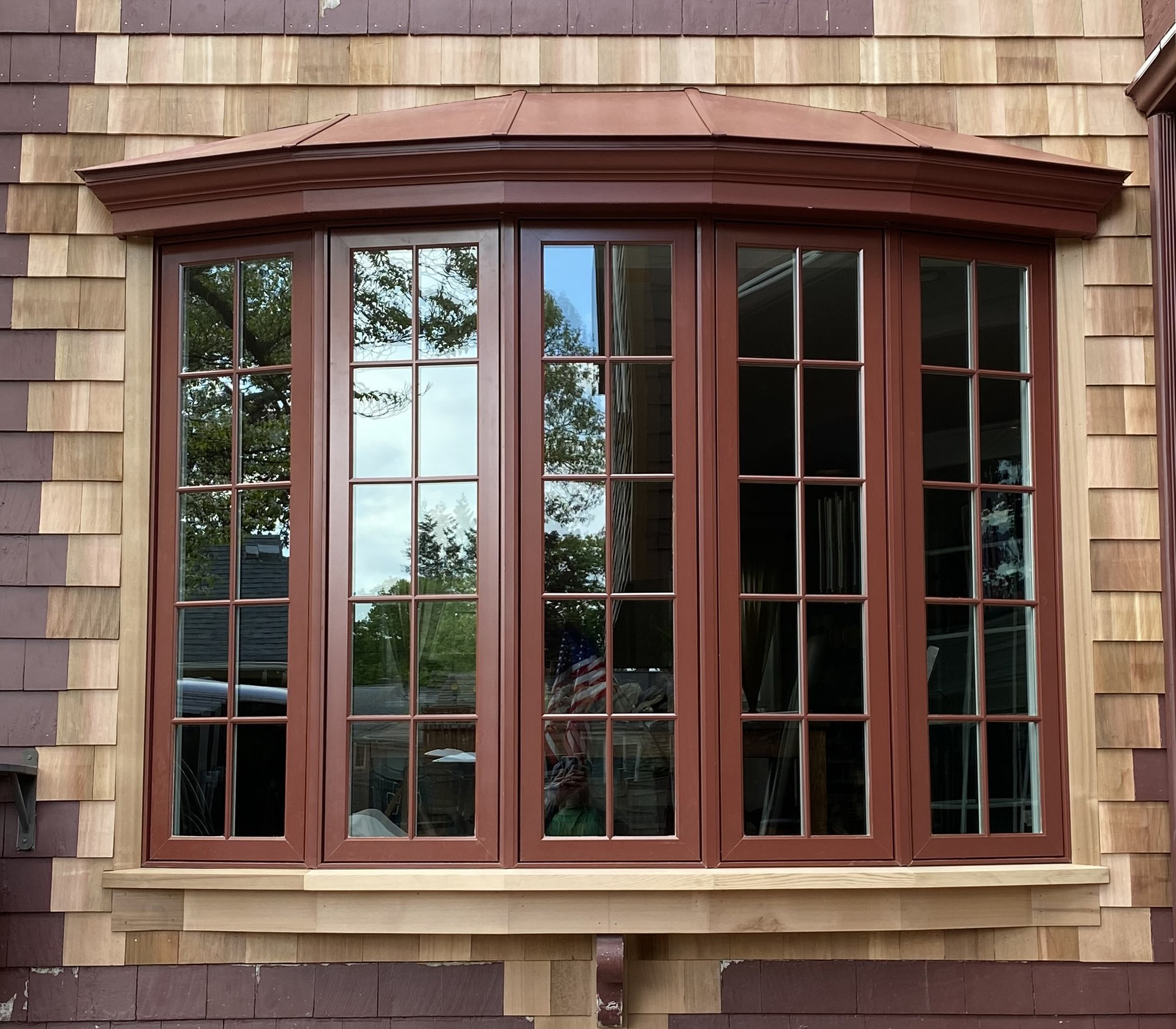 Islander coated roof to match wooden bow window