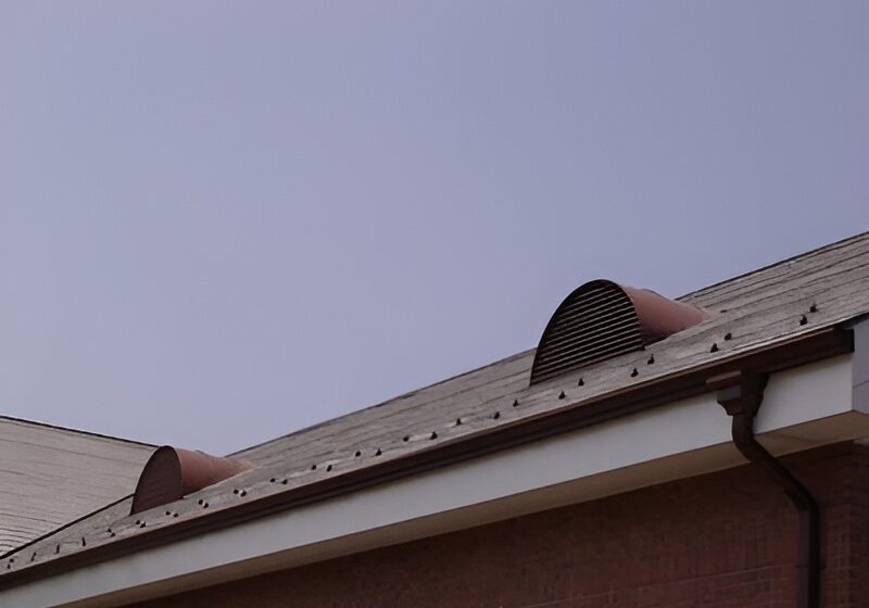 Two copper eyebrows installed on a roof of a home.